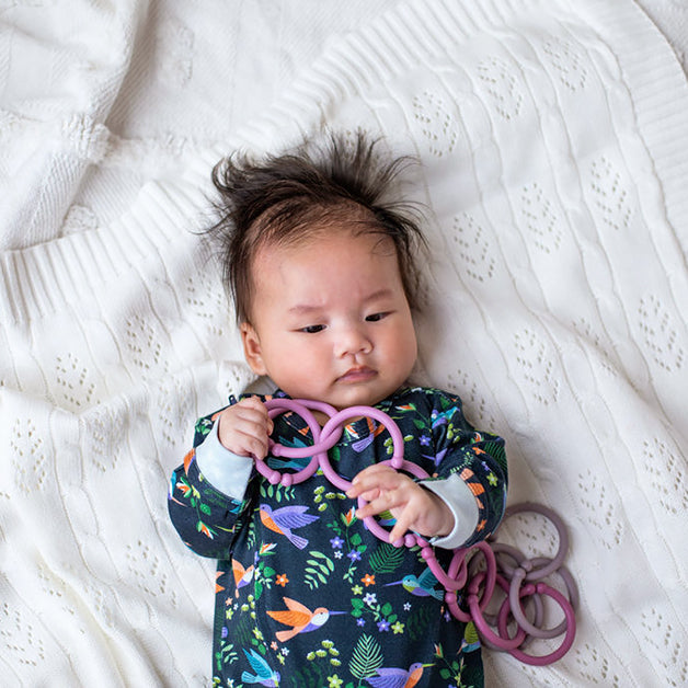 Baby Girl Welcome Hamper featuring a baby girl with pink sensory teething rings for thoughtful new baby gifting and same day delivery across Australia