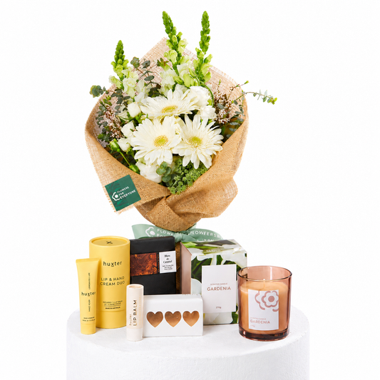 Pure Comfort Hamper with white flower bouquet in burlap plus Huxter hand care chocolate and a Gardenia candle for sympathy or thank you flowers