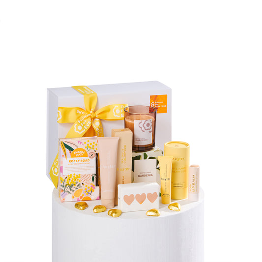 Sending Hugs Hamper with a yellow ribbon gift box candle hand care treats and heart chocolates for thoughtful gifting with same day delivery flowers