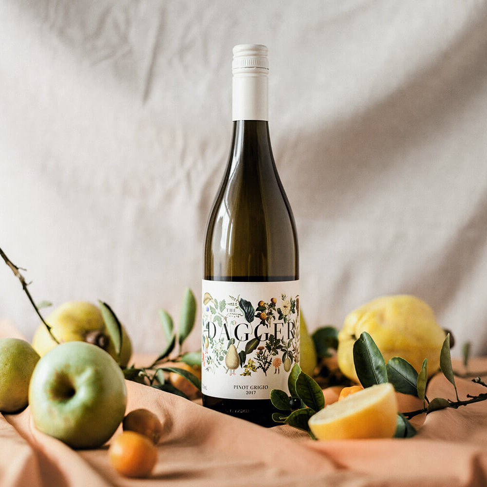 Cloak & Dagger Pino Grigio White Wine bottle styled with apples pears and citrus fruit from the Wine Extra WOW and All gifts collections