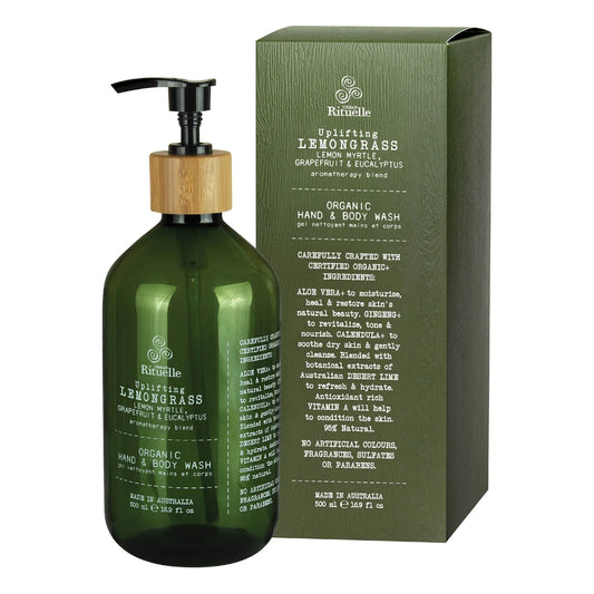 Urban Rituelle Hand & Body Wash in a green pump bottle with wooden accent next to green packaging box featuring lemongrass and eucalyptus aromatherapy blend details